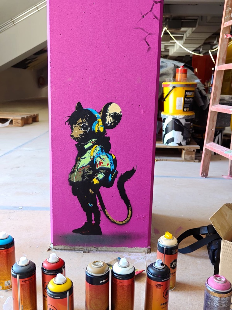 Mural on a column, spray cans on the floor